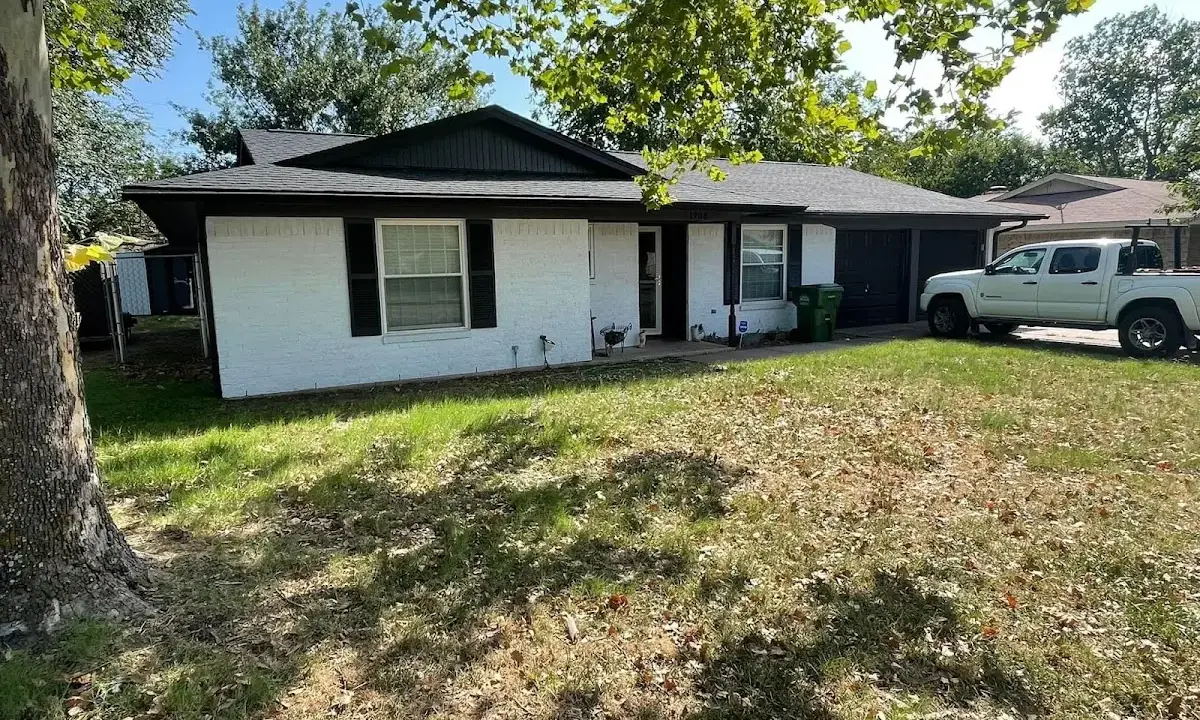 Professional roofing crew working on a residential roof in Patterson